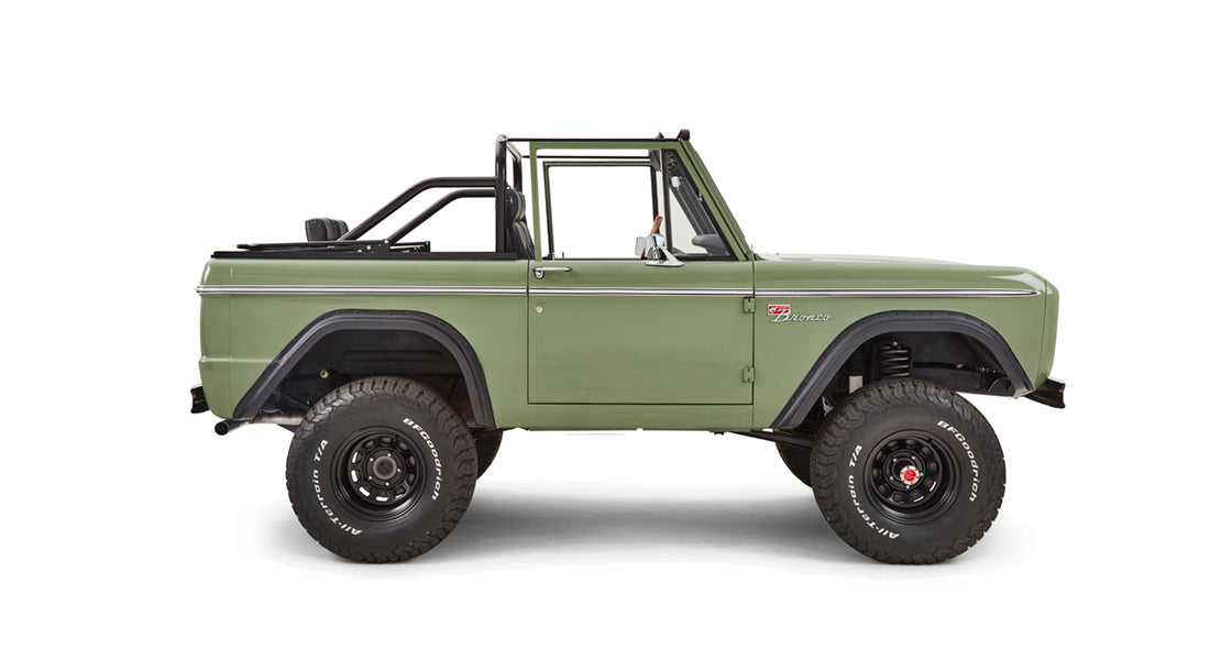 Side profile of green Classic Ford Bronco with black fender flares and off-road tires