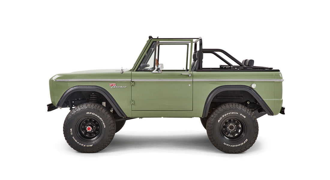 Green front grille of Classic Ford Bronco showing FORD letters and amber turn signals