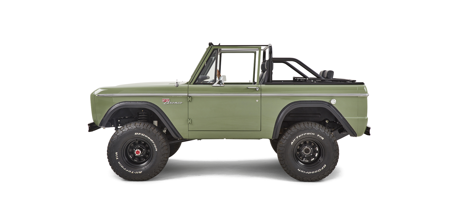 Side profile of green Classic Ford Bronco without a roof showing wheels and suspension