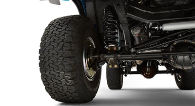 Close-up view of rear suspension and tires of classic Ford Bronco with coil springs and shock absorbers