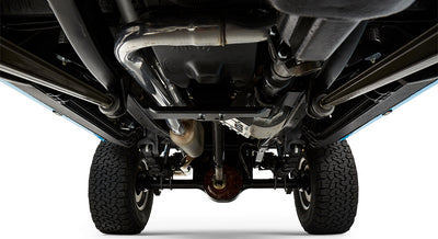 Undercarriage rear view showing exhaust system, differential, suspension, and tires of a classic Ford Bronco