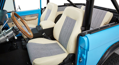 Front seats and interior door panel inside Classic Ford Bronco with beige and checked fabric