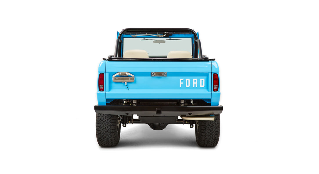 Rear view of blue Classic Ford Bronco showing tailgate closed with large FORD letters