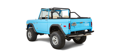 Rear three-quarter view of bright blue Classic Ford Bronco with Ford logo on tailgate.