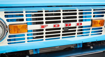 Close-up of front grille of Classic Ford Bronco with white and blue colors and red FORD letters