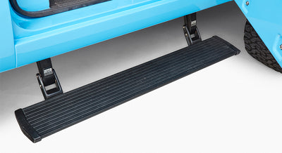 Black running board step on Classic Ford Bronco beneath blue door area