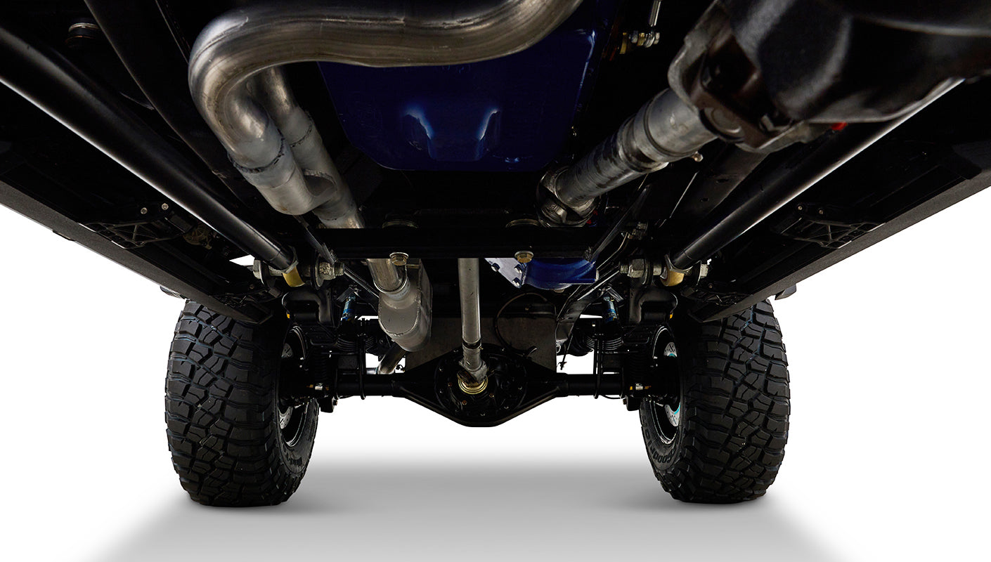 Undercarriage view of Classic Ford Bronco showing suspension components and tires.