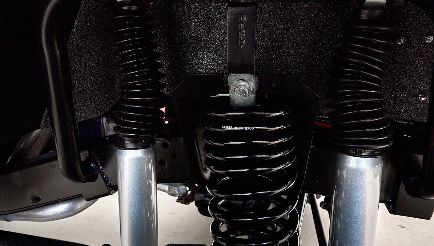 Close-up of Classic Ford Bronco suspension coil springs and shocks.