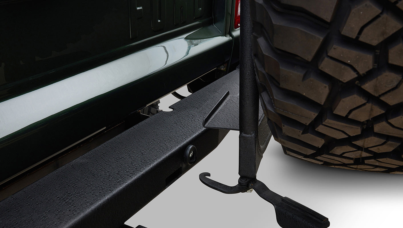 Black round Kicker speaker embedded in quilted brown leather panel of Classic Ford Bronco interior