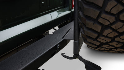 Black round Kicker speaker embedded in quilted brown leather panel of Classic Ford Bronco interior