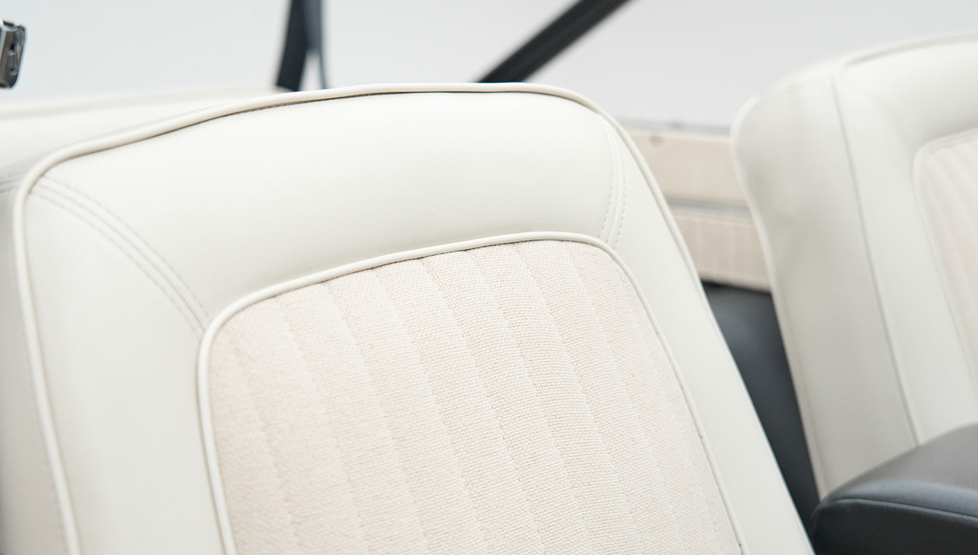 Close-up of white upholstery on a seat inside Classic Ford Bronco