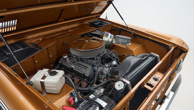 Engine bay of Classic Ford Bronco with visible air filter and brake booster