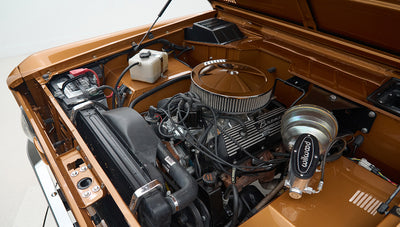 Wider view of engine bay featuring air filter, radiator, and brake components in Classic Ford Bronco