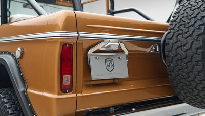 Rear corner of Classic Ford Bronco in Saddle Bronze with spare tire mounted on tailgate