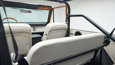Interior rear view of Classic Ford Bronco showing white seats and roll cage