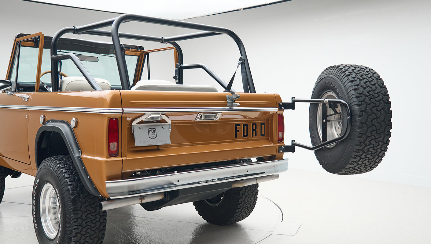 Rear and side view of Classic Ford Bronco in Saddle Bronze with spare tire on tailgate