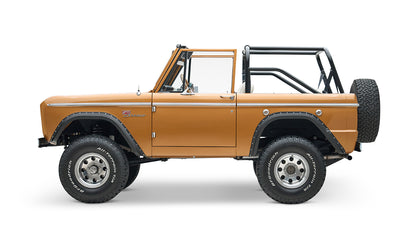 Profile side view of Classic Ford Bronco in saddle bronze color with black wheel arches on white background