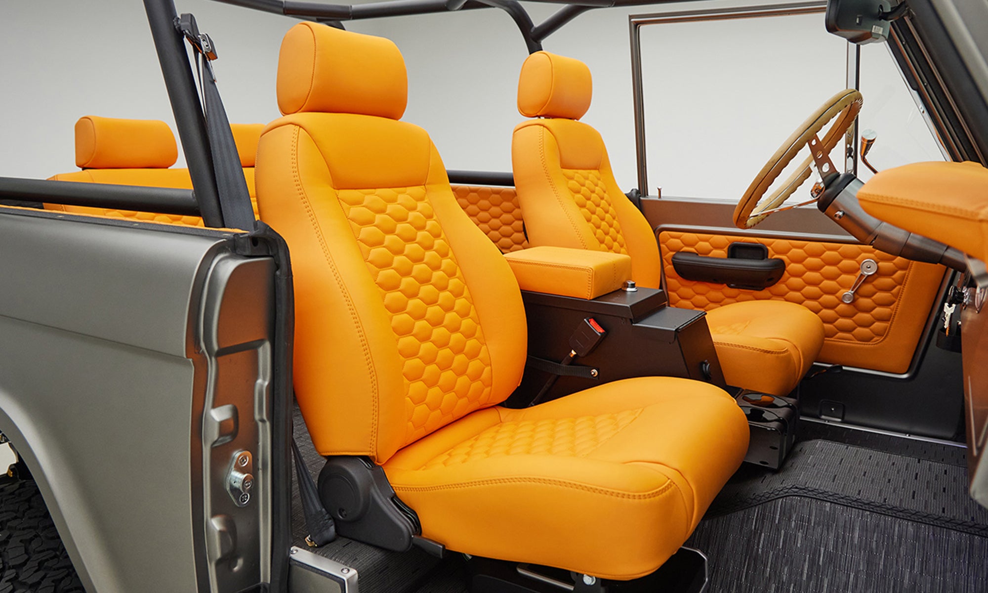 1972 classic ford bronco in matte silver over orange leather interior coyote series passenger interior