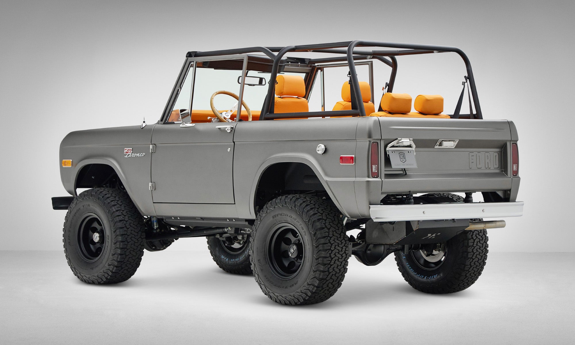 1972 classic ford bronco in matte silver over orange leather interior coyote series rear driver 3/4