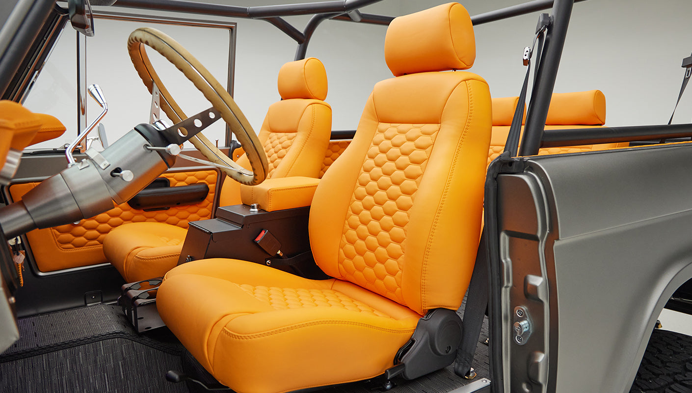 1972 classic ford bronco in matte silver with orange leather interior driver seat