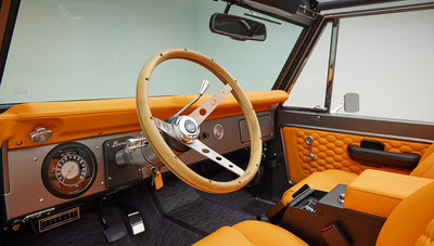 1972 classic ford bronco in matte silver with orange leather interior steering wheel