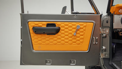 1972 classic ford bronco in matte silver with orange leather interior door panel