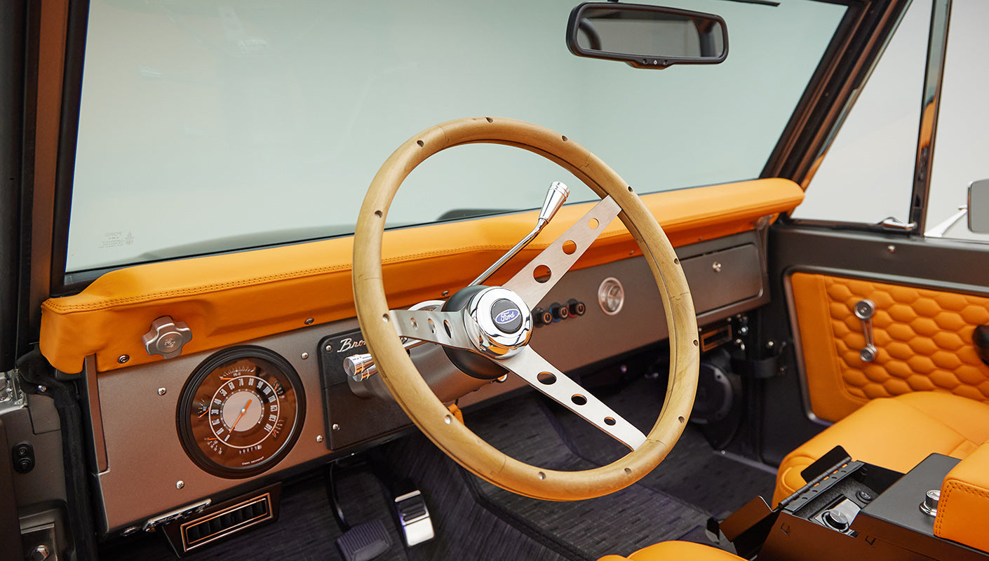 1972 classic ford bronco in matte silver with orange leather interior steering wheel