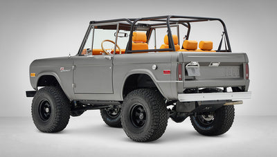 1972 Classic Ford Bronco in Matte Silver over Orange Leather interior rear driver 3/4