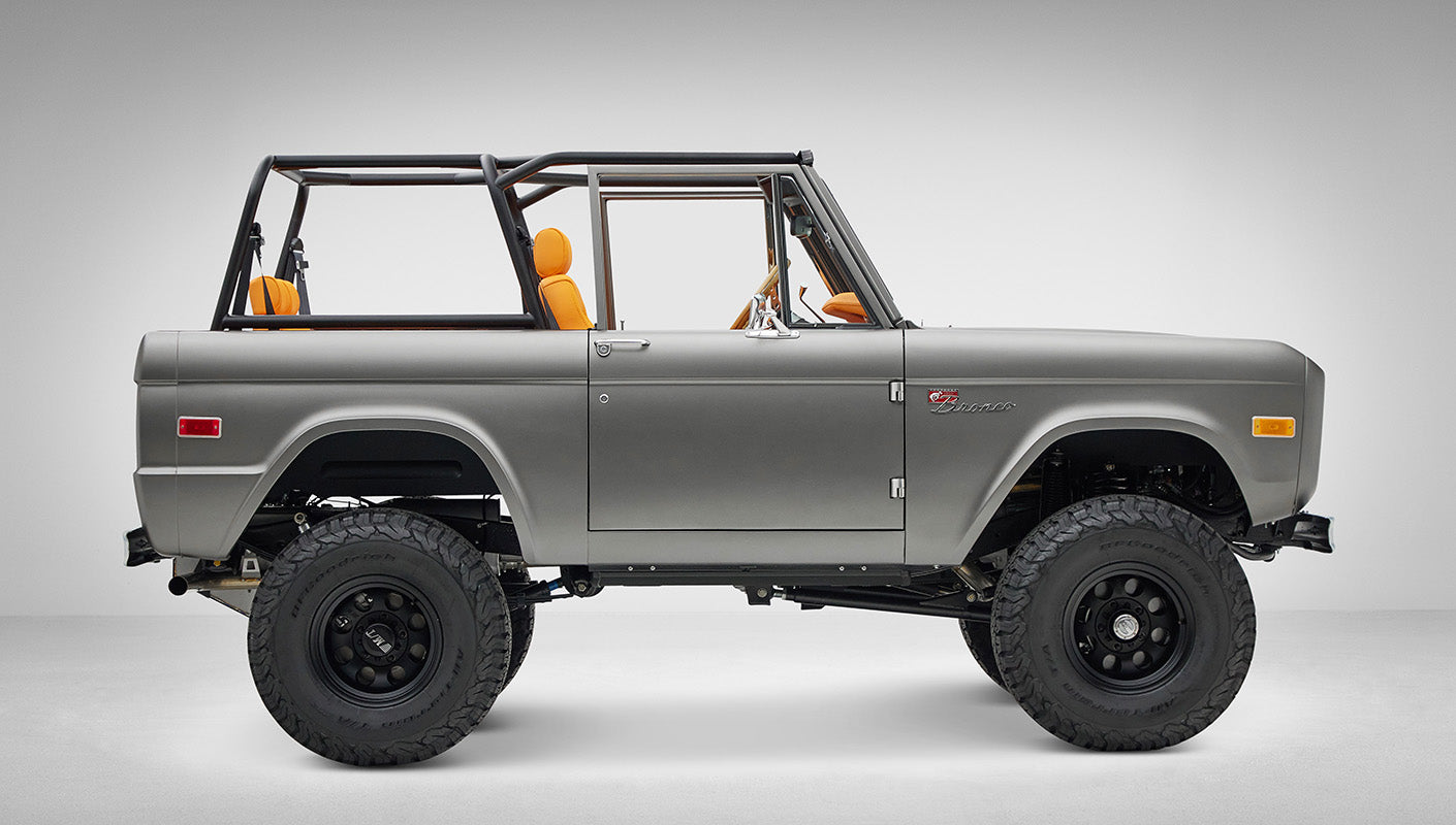 1972 Classic Ford Bronco in Matte Silver over Orange Leather interior passenger side profile