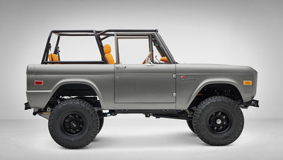 1972 Classic Ford Bronco in Matte Silver over Orange Leather interior passenger side profile