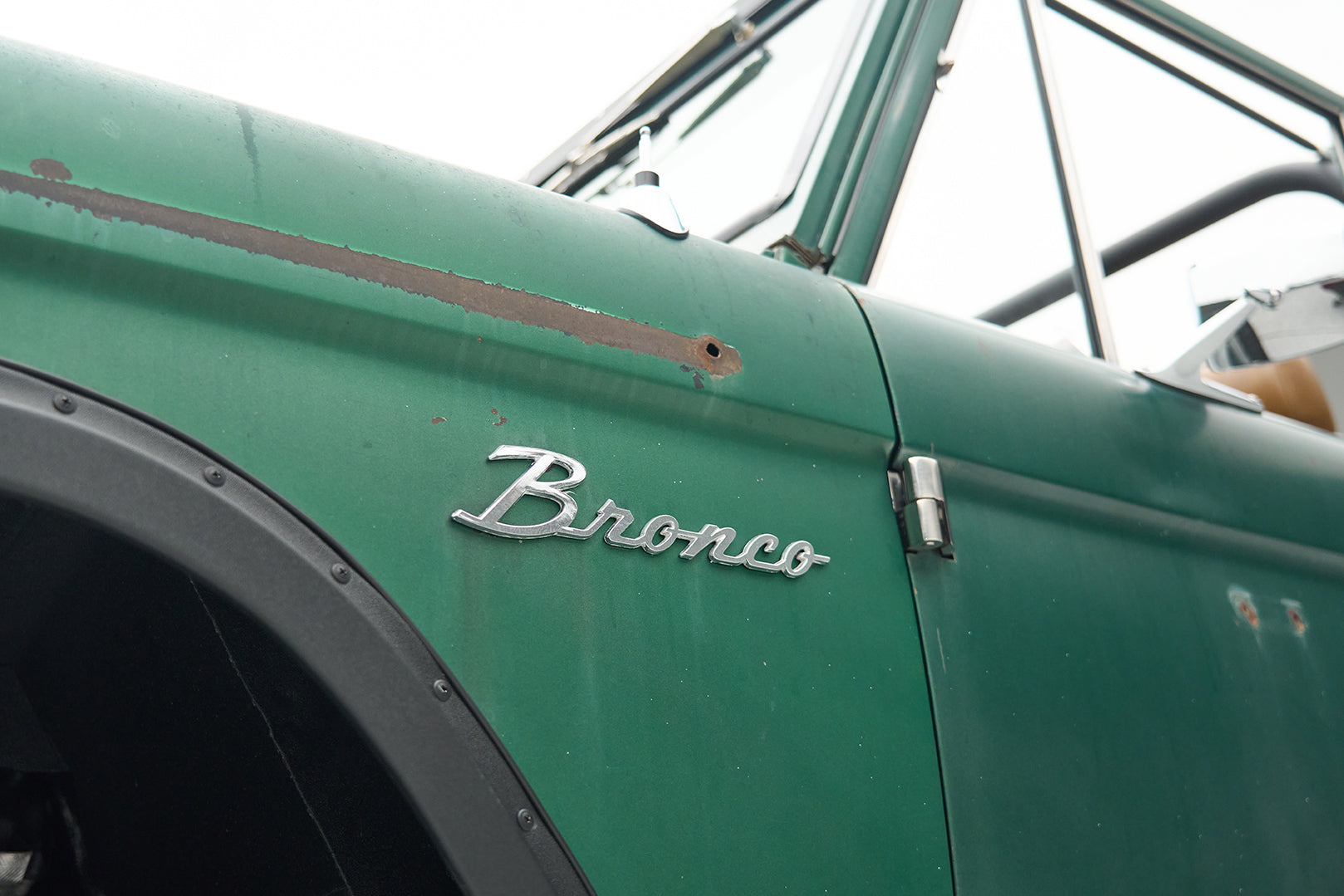 Close-up of Classic Ford Bronco front grill, left headlight and bumper
