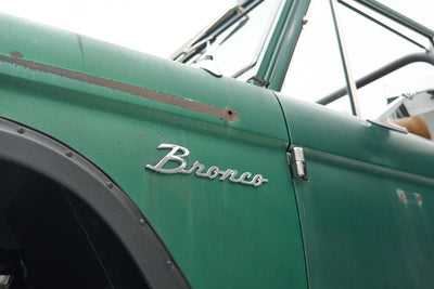 Close-up of Classic Ford Bronco front grill, left headlight and bumper
