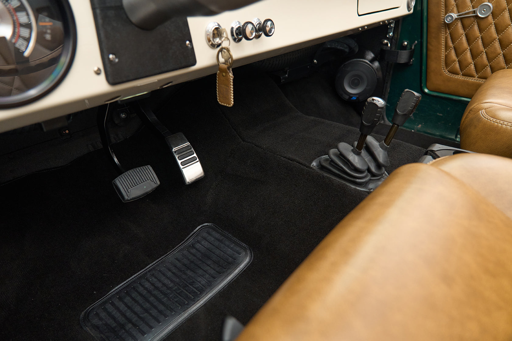 Classic Ford Bronco driver's side floor pedals, gear sticks and tan leather seats