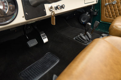 Classic Ford Bronco driver's side floor pedals, gear sticks and tan leather seats