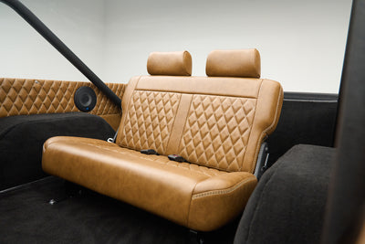 Rear tan leather quilted bench seat with black carpet interior