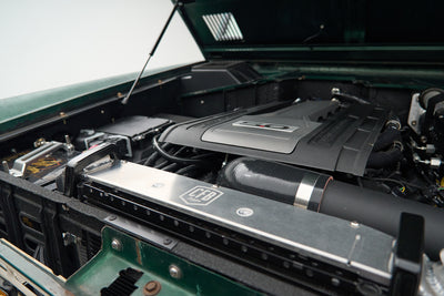 Engine bay of a Classic Ford Bronco with a 5.0-liter engine and CFB branded metal radiator support.