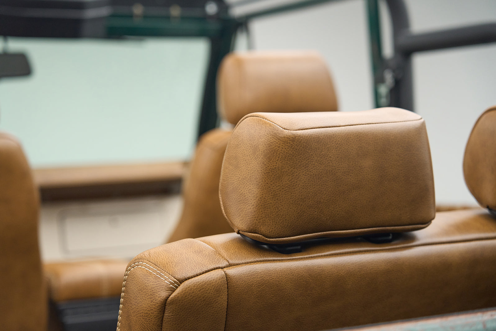 Brown leather headrests and seats inside a classic Ford Bronco