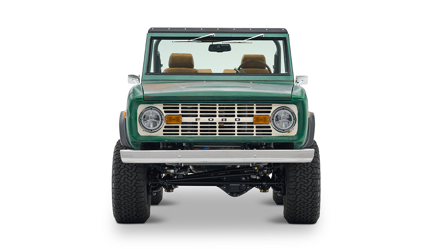 Classic Ford Bronco green with tan interior, left side profile on white background