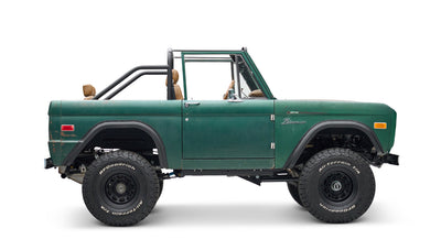 Classic Ford Bronco green with tan seating, right side profile on white background