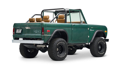 Classic Ford Bronco green with tan seats, rear side view angled on white background