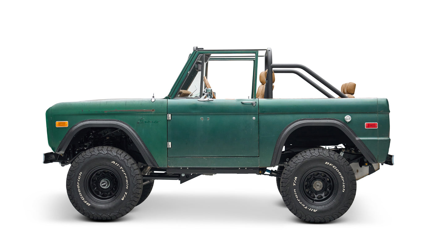 Classic Ford Bronco green with tan interior, side profile view on white background