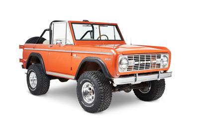 Three-quarter front view of orange Classic Ford Bronco with visible front and side details.