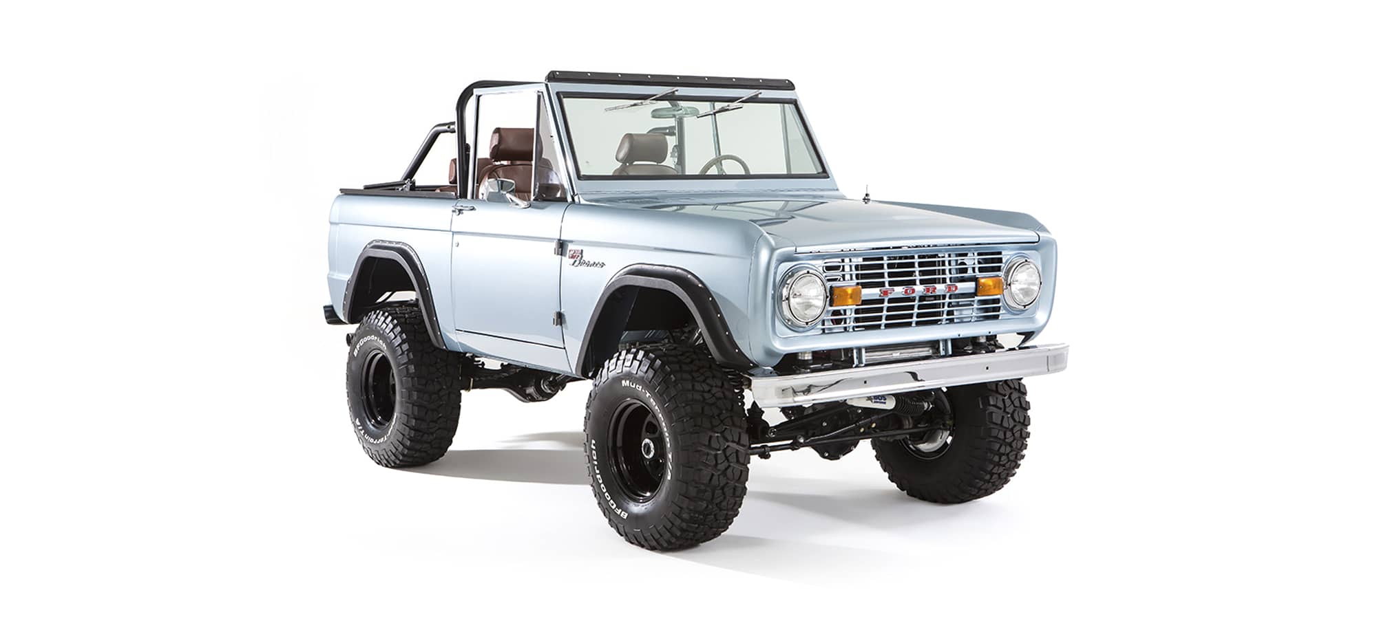 Three quarter front view of lifted light blue Classic Ford Bronco with open roof