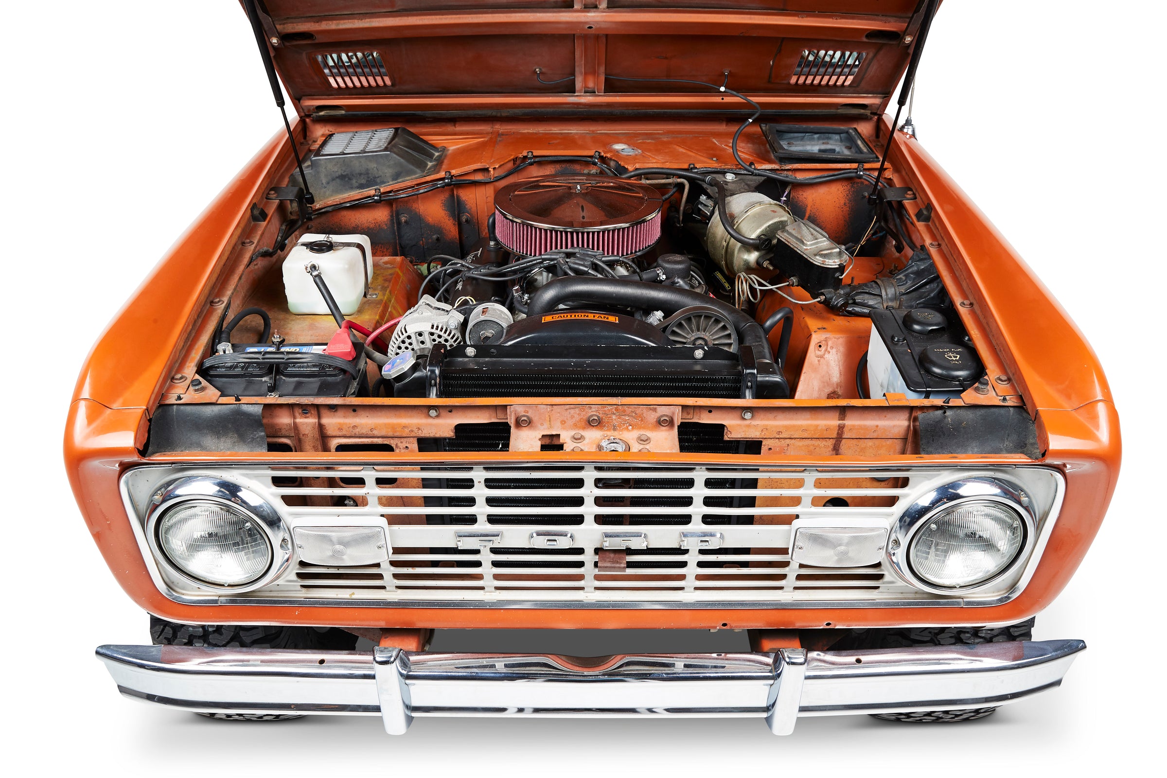 Classic Ford Bronco front with open hood showing engine and orange body.