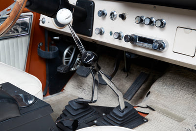 Interior view of Classic Ford Bronco showing gear shifters with Hurst and T-bar knobs.