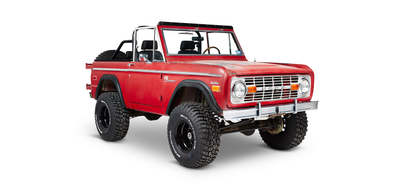 Red Classic Ford Bronco angled front view with off-road tires and open roof