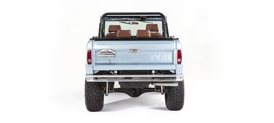 Rear view of light blue Classic Ford Bronco with exposed bumper and tires