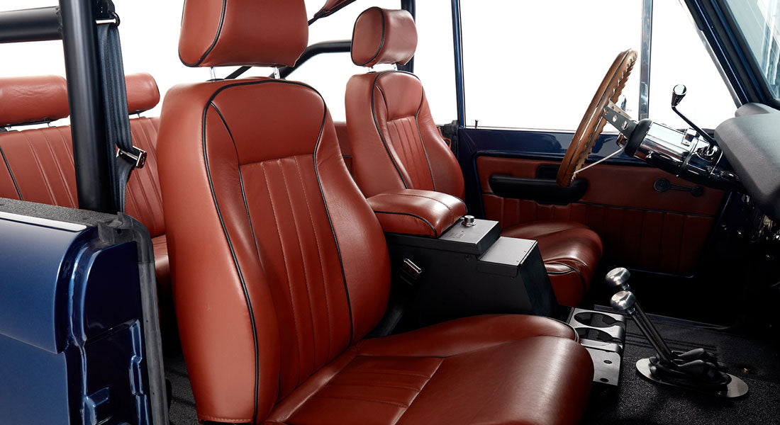 Interior of Classic Ford Bronco showing brown leather bucket seats and center console