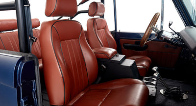 Interior of Classic Ford Bronco showing brown leather bucket seats and center console
