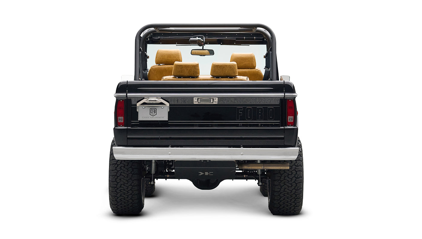 Rear view of black Classic Ford Bronco with lifted suspension and chrome wheels